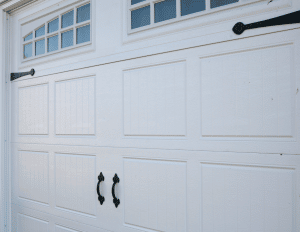 White garage door with windows and black handles